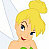 Pixelated image of a blonde fairy with blue eyes, green top, and translucent wings, smiling with one eye closed.