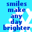 Blue text on a light blue background with white snowflake shapes, displaying the phrase "smiles make any day brighter" in two vertical