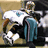 Pixelated image of a football player in teal and white uniform with number 25, labeled "THE BEST" above and "RUNNER #25 REGGIE BUSH" below on dark background.