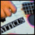 Pixelated image showing a guitar with visible frets and strings alongside pink text reading "ATTICUS" on a black background.
