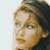 Static pixelated image of a person's face with light brown hair and neutral expression on white background.