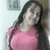 Pixelated image of a person with long dark hair wearing a pink top, positioned against a light background with a darker vertical element on the right.