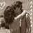 A sepia-toned image of two people embracing, with red text reading "Zac & Vanessa" and "true love" on a black background.