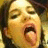 A pixelated image of a person with mouth open and tongue extended next to pink text on black background.