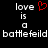 Pixelated text reads 'love is a battlefield' with red heart symbol replacing the letter O in 'love', displayed on black background.
