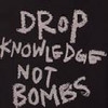 Static image with white text on black background reading 'DROP KNOWLEDGE NOT BOMBS' in stylized lettering.