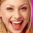 Pixelated image of a smiling person with light hair on left, bright pink background on right with blue text 'keely' in lowercase.