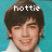 Pixelated portrait of a person with dark brown hair against a teal background, with the word 'hottie' in white pixelated text above the head.