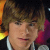 A 50x50 pixel animated contact sheet showing two frames of a cartoon-style character with brown hair and a black jacket, one frame featuring a pink heart symbol on the right side.