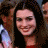 A pixelated image shows a person with long dark hair and red clothing on the left, next to green text reading 'OriginalIcons.com' on a solid background.