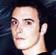 Pixelated static image of a person's face with dark hair and light skin against a dark background, appearing as an AOL Instant Messenger buddy icon.
