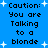 Blue background with white starbursts and repeated black pixelated text reading "Caution: You are Talking to a blonde" in four identical vertical sections.