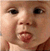 Six pixelated close-up views of a baby's face arranged in two , each showing distinct facial expressions including tongue-out, smiling, and open-mouthed