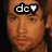 Pixelated close-up of a person's face with brown hair, wearing black headband displaying white 'dc' letters and heart symbol.