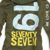 Olive green hoodie with light blue '16' graphic, yellow 'SEVENTY SEVEN' text, and vertical white 'AE LOVE' text on right sleeve.