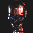 Pixelated static image of a humanoid figure with glowing red eyes and blue accents on dark background.