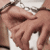 Repeated pattern of hands in handcuffs with animated text cycling through 'im', 'gonna', 'stick', 'with', and 'you' on a light background.