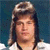 Static pixelated image of a person with long dark hair wearing a light-colored headband against a blue background.