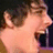 Pixelated image of a person with brown hair and open mouth, red text reading 'Gerard is... shekshay' on black background.
