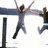 Animated icon shows two people jumping with arms raised on left, two people in sunglasses making peace signs on right, and four of colored hearts below