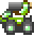 Pixelated green and brown figure with white accents, dark gray base, light green circular elements on lower sections.