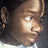 Pixelated close-up of a person's face with light brown hair, showing eyes and nose against dark background.