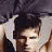 A 48x48 pixel animated contact sheet showing three sequential frames of a shirtless male figure with dark hair, wearing a necklace and jeans, in various poses against a gray background.