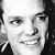 A grayscale pixelated close-up of a person's face showing eyes, nose, mouth, and dark hair against a light background.