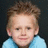 A pixelated image split into two sections: a person with light brown hair and blue clothing on the left, and text reading 'Tomie is my life!' in black-and-white block letters on the right.