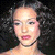 Pixelated static image of a person with light skin tone, dark hair, and pink lips against a black background.