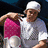 A pixelated image shows a person in white clothing holding pink fabric, with green text blocks on the right side.