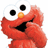 Red puppet character with large white eyes and orange nose, hands near mouth on white background; red text 'BABY ELMO' above black area with three dots and 'o yeah' below.