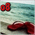 Red flip-flops on a beach with turquoise water; red '08' text in top-left corner.