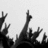 Black and white pixelated image showing multiple raised hands against a light background, with varying hand positions and partial fingers visible.