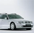 A static pixelated image of a white vehicle with dark green roof and black accents on a light gray background.