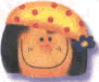 Two side-by-side cartoon faces with orange skin, black hair, and red noses; left face wears a yellow polka-dot hat with blue flower, right has red bow.
