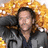 A pixelated image of a person with dark hair and a gray jacket against a yellow floral background, with overlaid white text on a dark green field.