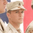Pixelated static image of a person wearing a light-colored cap and shirt, with brown hair visible beneath the cap.