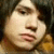 Static pixelated image of a person's face with light skin tone, dark hair, and closed eyes in profile view.