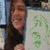 A person with long dark hair holds a light-colored sign with green text, while the top-right corner displays 'BFFs' in pink block letters.
