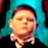 Pixelated static image of a person with closed eyes wearing a blue head covering against dark background, rendered in low-resolution 256x256 pixels.