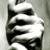 Pixelated grayscale image of a stylized figure with layered black and white shapes against a light gray background.
