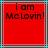 Red background with black text reading "I am McLovin!" in pixelated font, framed by cyan and gray lines