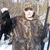 A pixelated image shows a person with long brown hair and dark clothing on the left, next to green background with bold orange text reading "That's My Crow".