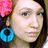 A person with brown hair, a pink flower in their hair, and blue hoop earrings appears in four showing slight head position changes