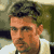 Static 50x50 pixel icon showing a close-up of a person's face with short dark hair, light skin tone, and visible facial features including eyes, nose, mouth, and ear against a blurred background.
