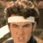 A pixelated image of a person with brown hair and a white headband, next to a text overlay reading "i'm burnin up for him baby!!!" with a colorful abstract background.