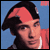 Pixelated static image of a person wearing a red headband and dark hair against a blue background with partial red clothing visible.