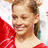 Pixelated image of a person in red clothing with a large bow, next to purple text reading 'Shawn Johnson' on black background.