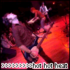A static image of a person playing guitar on stage with red lighting and text reading 'hot hot heat' at the bottom.